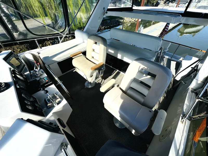 Slide: The Image of 1991 Ocean Alexander 440 Sundeck CPMY cockpit with helm chairs and control panel. - 28