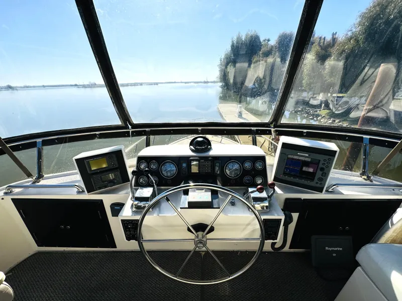 Slide: The Image of Helm of 1991 Ocean Alexander 440 Sundeck CPMY with navigational instruments and scenic water view. - 29