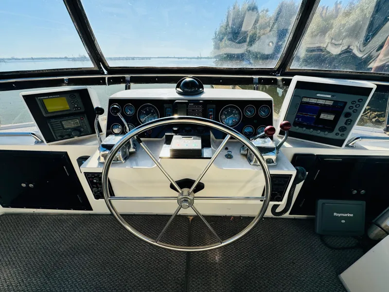 Slide: The Image of Helm of 1991 Ocean Alexander 440 Sundeck CPMY with navigation instruments and steering wheel. - 30