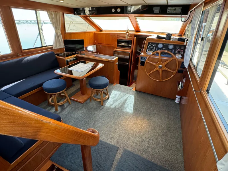Slide: The Image of Interior of 1991 Ocean Alexander 440 Sundeck CPMY with helm, seating, and wooden accents. - 35