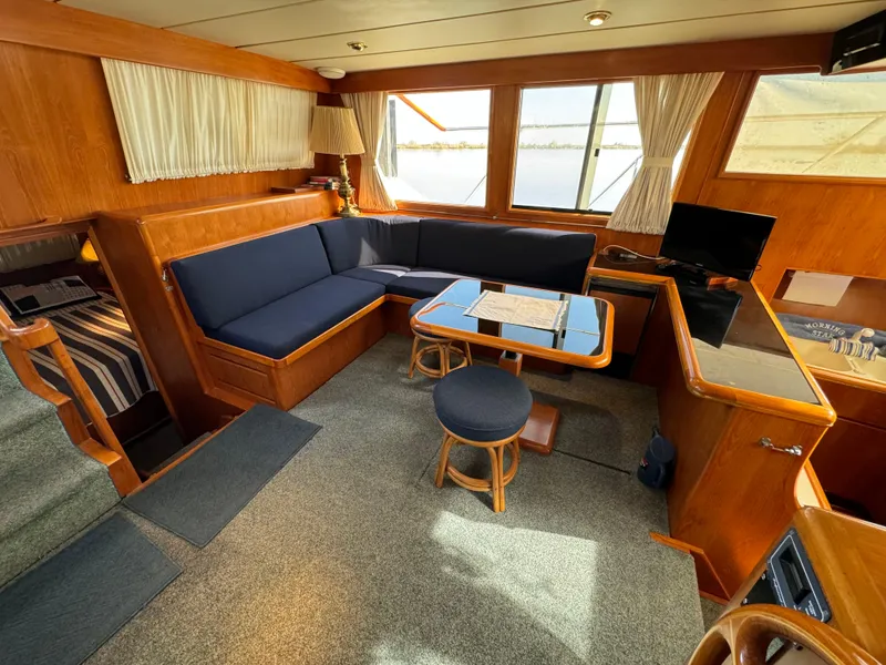Slide: The Image of Interior of 1991 Ocean Alexander 440 Sundeck CPMY with blue seating and wooden accents. - 37