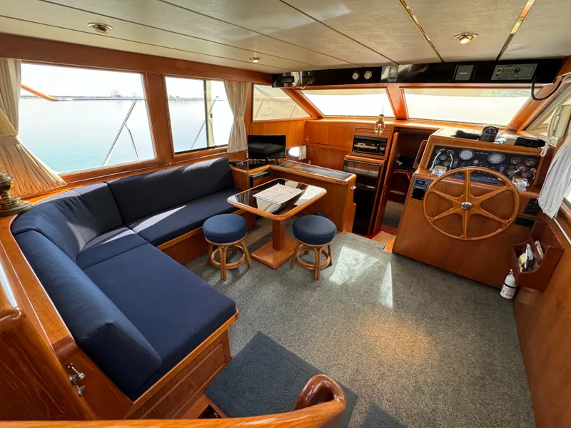 Slide: The Image of Luxurious 1991 Ocean Alexander 440 Sundeck CPMY interior with elegant wood finish and spacious seating. - 4