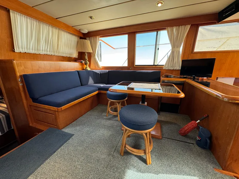 Slide: The Image of Interior of 1991 Ocean Alexander 440 Sundeck CPMY with blue seating and wooden accents. - 41