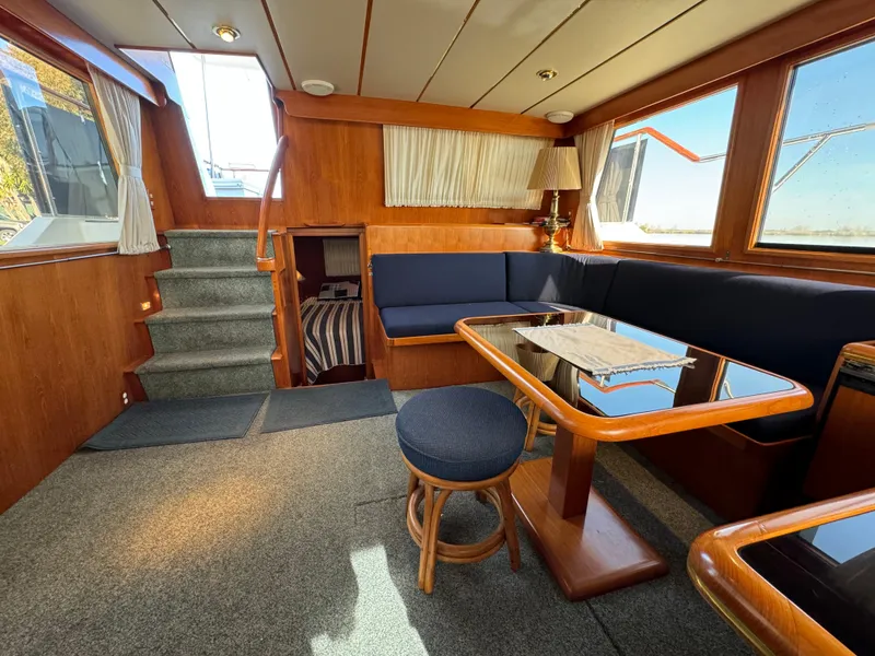 Slide: The Image of Interior of 1991 Ocean Alexander 440 Sundeck CPMY with wood accents and seating area. - 42