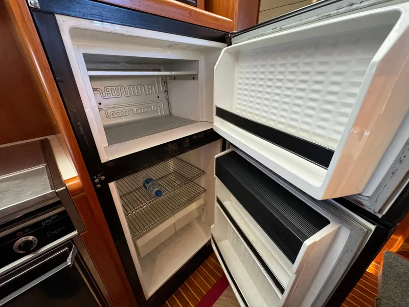 Slide: The Image of Open refrigerator and freezer on 1991 Ocean Alexander 440 Sundeck CPMY yacht. - 48