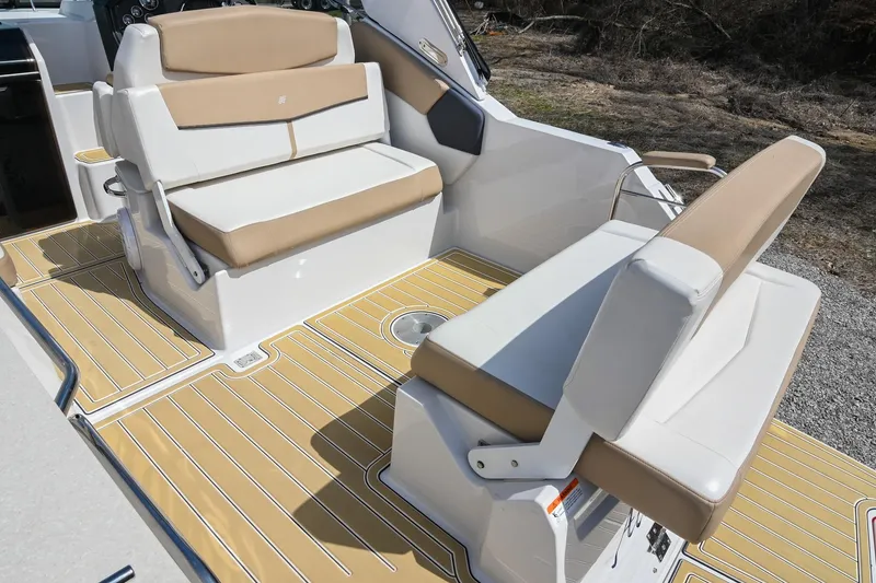 Slide: The Image of 2014 Four Winns V275 boat interior with beige seating and wood-patterned flooring. - 11