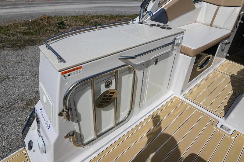 Slide: The Image of 2014 Four Winns V275 boat interior with seating and storage area. - 15