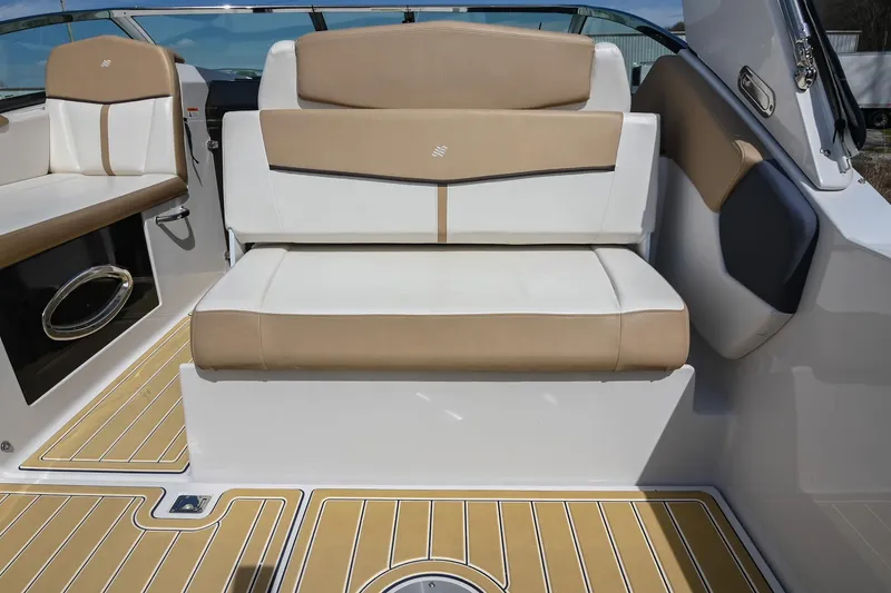 Slide: The Image of 2014 Four Winns V275 boat interior with beige and white seating, teak-style flooring. - 16