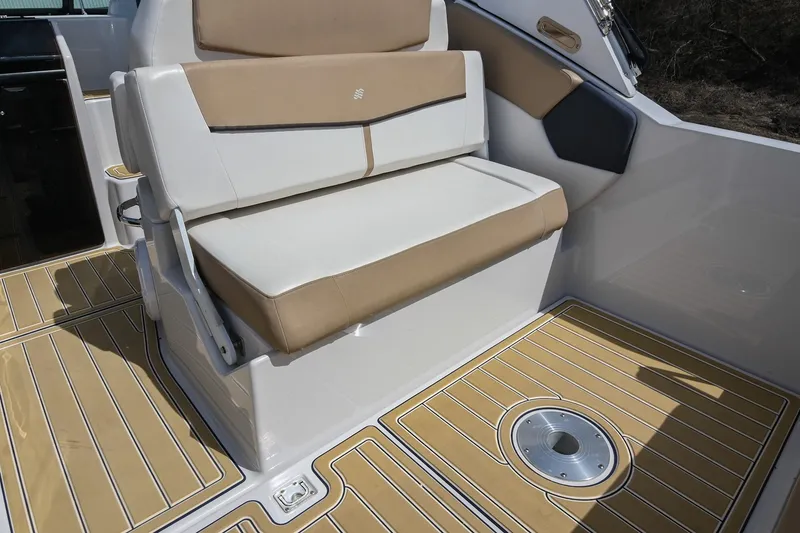 Slide: The Image of 2014 Four Winns V275 boat interior with tan and white seating and teak-style flooring. - 17
