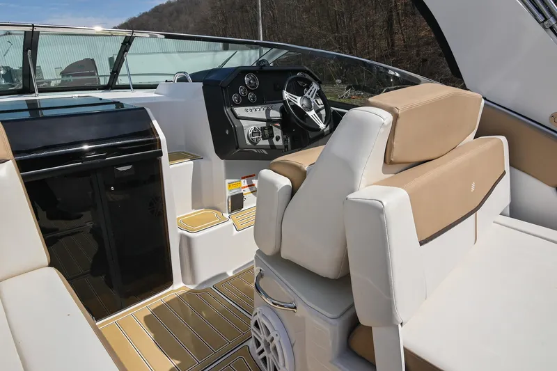 Slide: The Image of 2014 Four Winns V275 boat interior with beige seating and modern dashboard. - 20