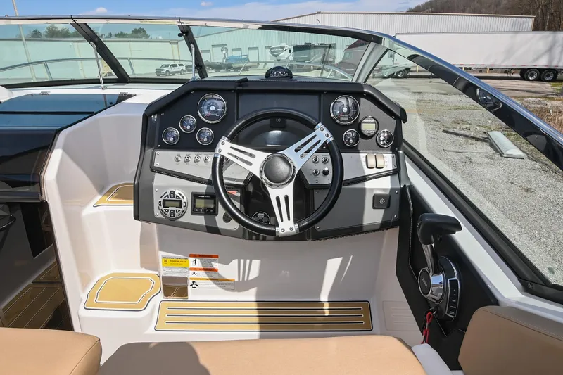 Slide: The Image of 2014 Four Winns V275 boat dashboard with steering wheel and control panel. - 21