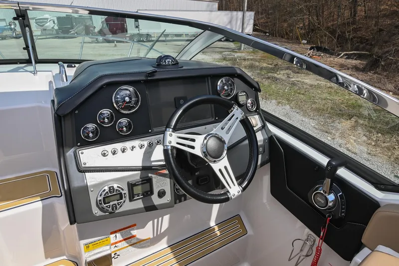 Slide: The Image of 2014 Four Winns V275 boat dashboard with steering wheel and control panel. - 22