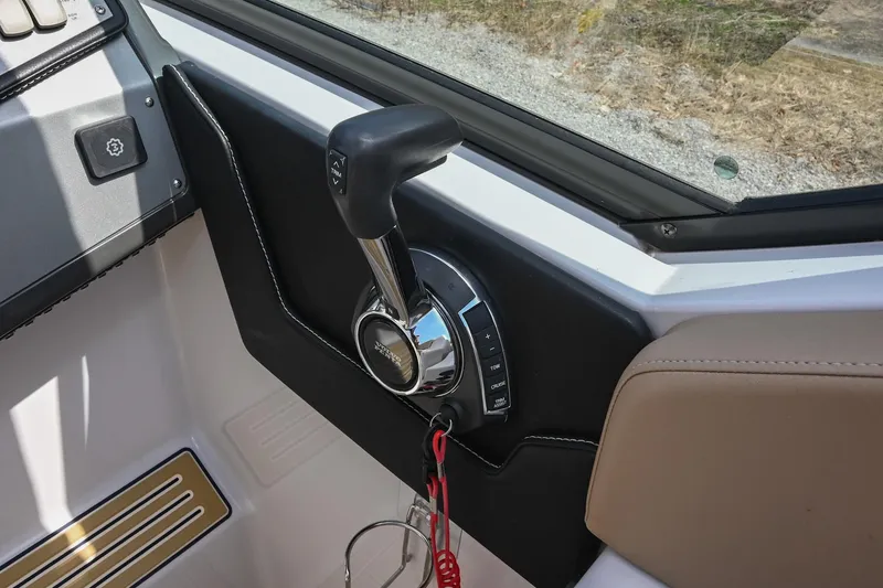Slide: The Image of Throttle control of 2014 Four Winns V275 boat, featuring sleek design and ergonomic handle. - 23