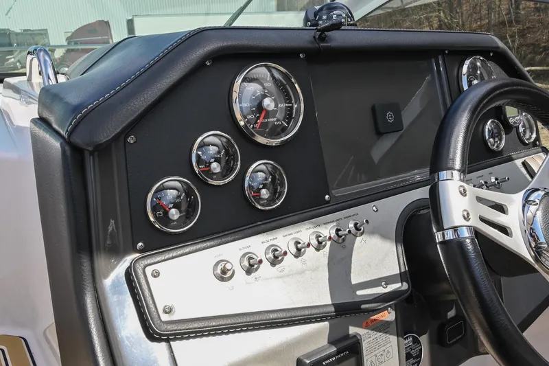 Slide: The Image of Dashboard of 2014 Four Winns V275 boat with gauges and steering wheel. - 25