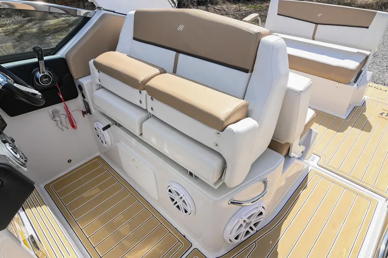 Slide: The Image of 2014 Four Winns V275 boat interior with beige seating and modern dashboard. - 27