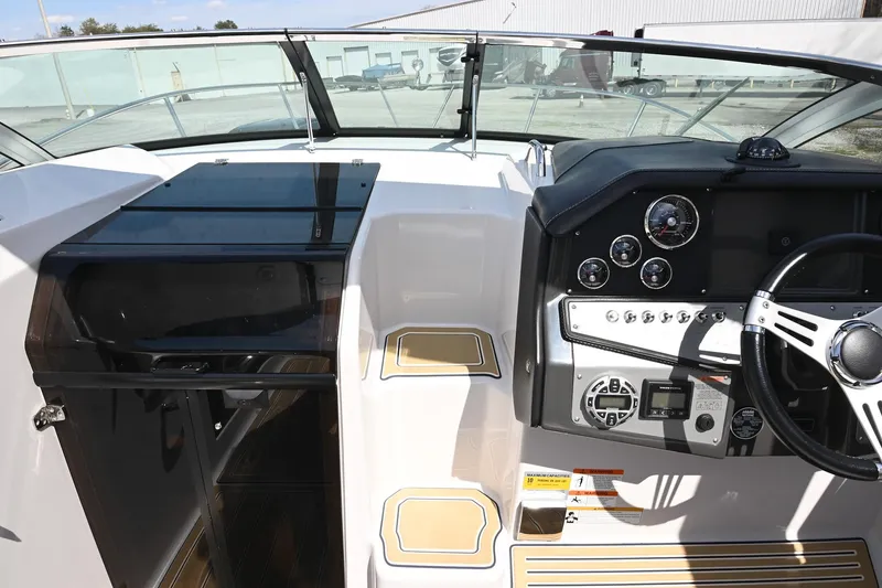 Slide: The Image of 2014 Four Winns V275 boat cockpit with steering wheel and control panel. - 29