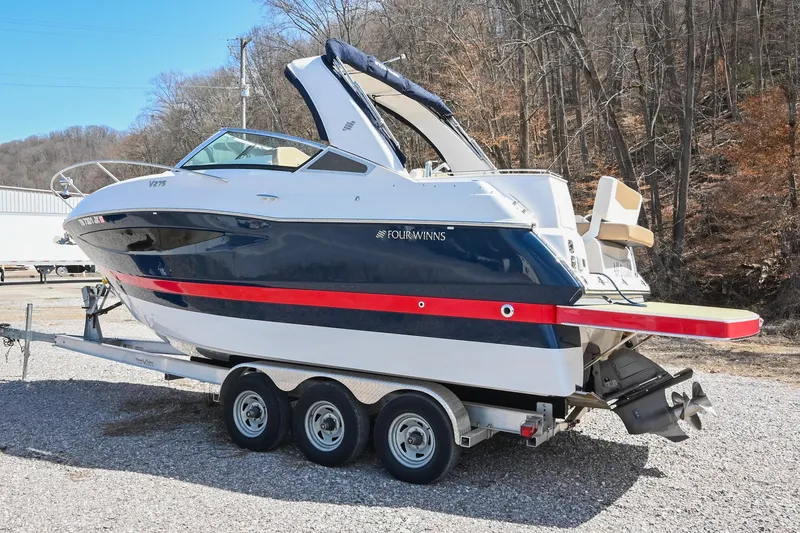 Slide: The Image of 2014 Four Winns V275 boat on a trailer, parked outdoors. - 3