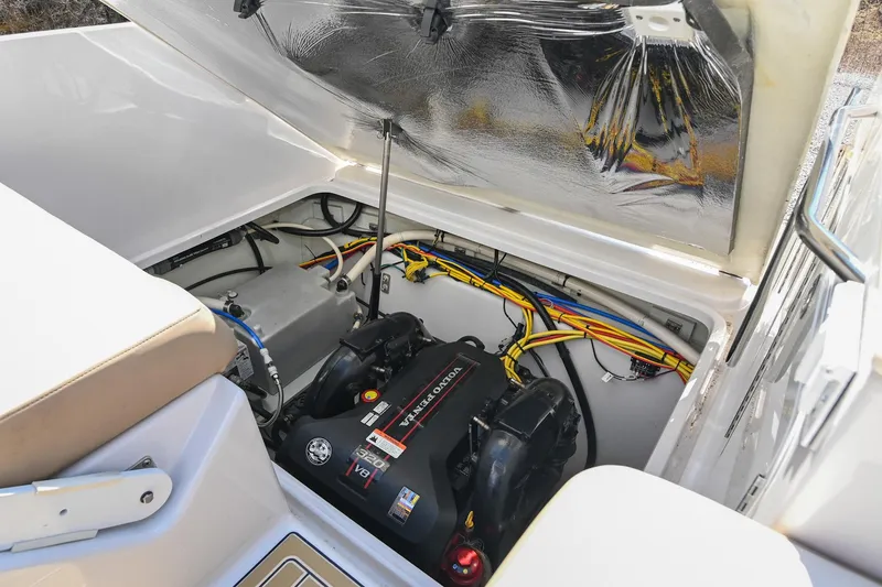 Slide: The Image of 2014 Four Winns V275 boat engine compartment with visible wiring and components. - 31