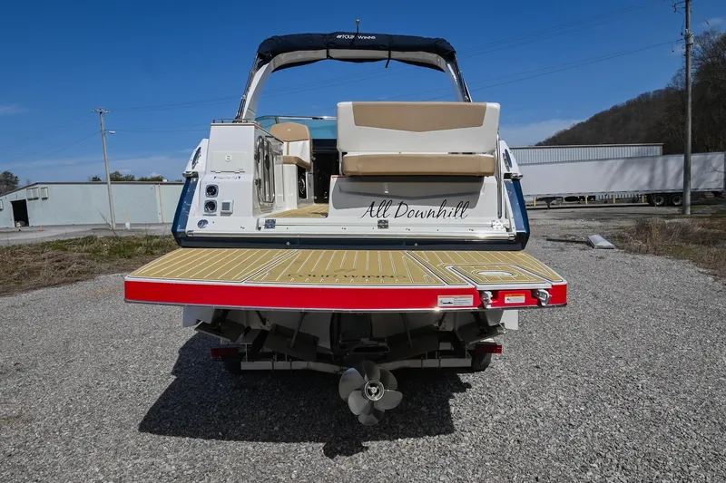 Slide: The Image of 2014 Four Winns V275 boat, rear view, on gravel, with swim platform and seating. - 4