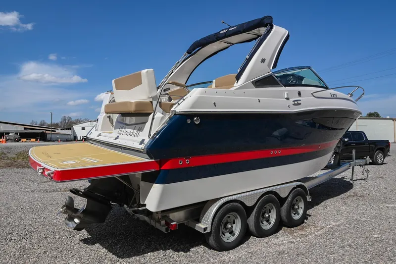 Slide: The Image of 2014 Four Winns V275 boat on trailer, featuring sleek design and spacious deck. - 5