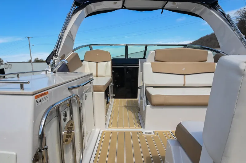 Slide: The Image of 2014 Four Winns V275 boat interior with beige seating and sleek design. - 9
