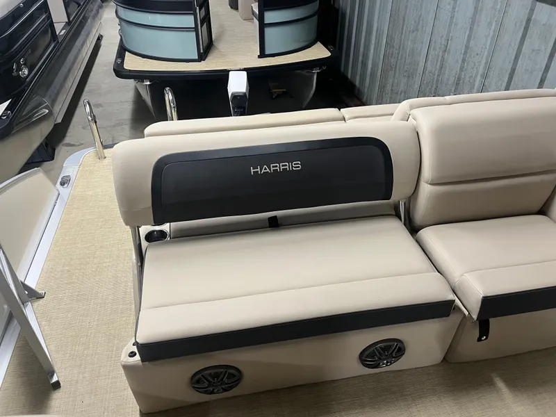 Slide: The Image of 2025 Harris Cruiser 210 boat interior with beige seating and black accents. - 2