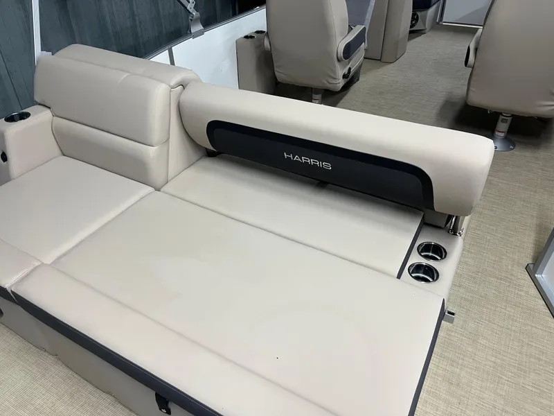 Slide: The Image of 2025 Harris Cruiser 210 interior with beige seating and cup holders. - 3