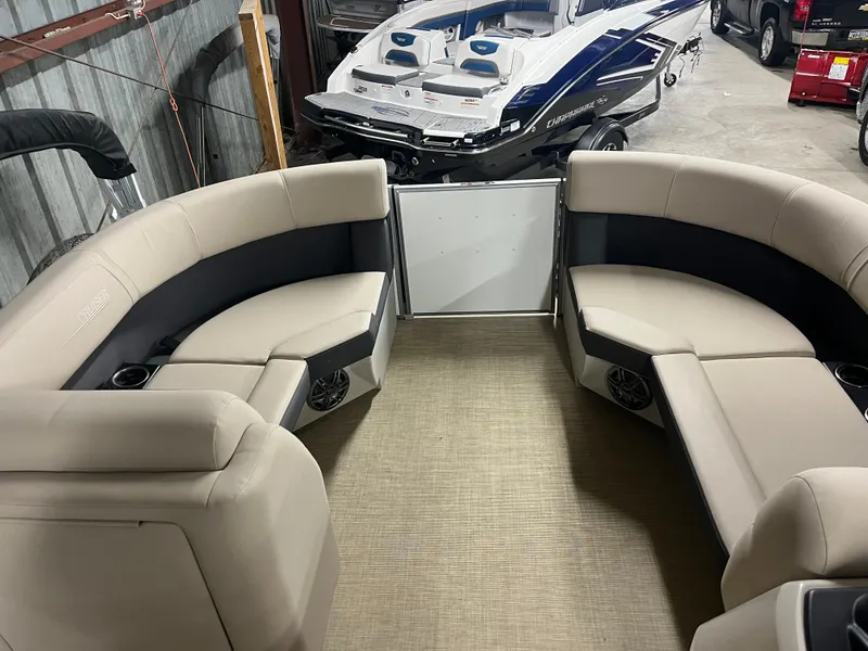 Slide: The Image of 2025 Harris Cruiser 210 interior with beige seating, stored in a garage. - 6