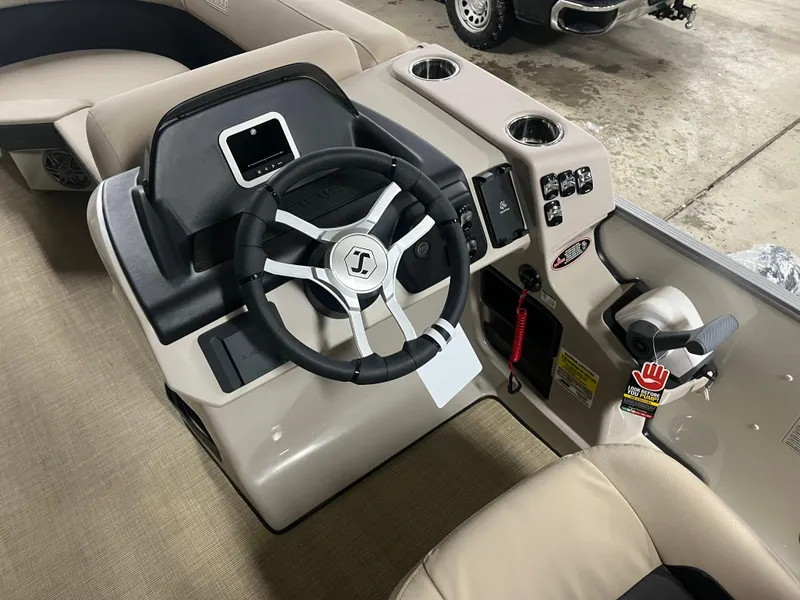 Slide: The Image of 2025 Harris Cruiser 210 boat dashboard with steering wheel and control panel. - 7