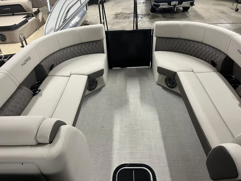 Slide: The Image of 2025 Harris Sunliner 230 boat interior with plush seating and modern design. - 10