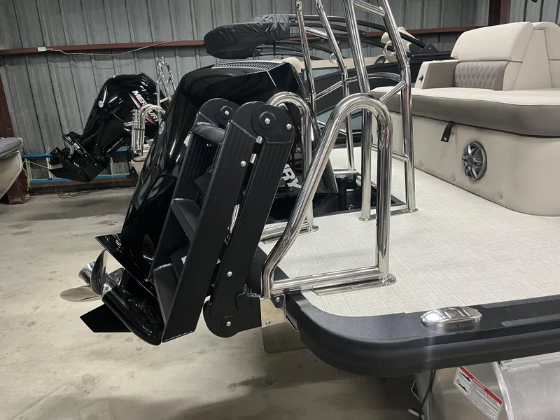 Slide: The Image of 2025 Harris Sunliner 230 boat with stainless steel ladder and seating in a storage area. - 6