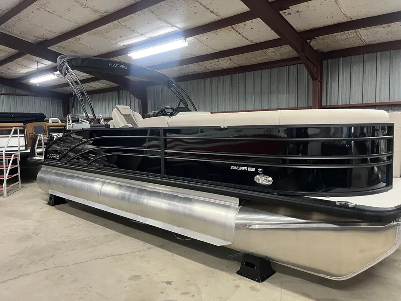 Slide: The Image of 2025 Harris Sunliner 230 pontoon boat in a warehouse setting. - 8