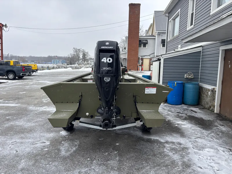 Slide: The Image of 2025 Crestliner 1660 Retriever FCC boat with Mercury 40 HP engine in snowy driveway. - 3