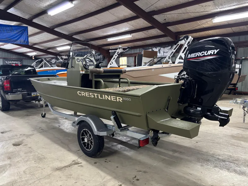 Slide: The Image of 2025 Crestliner 1660 Retriever FCC boat with Mercury engine in a warehouse setting. - 4