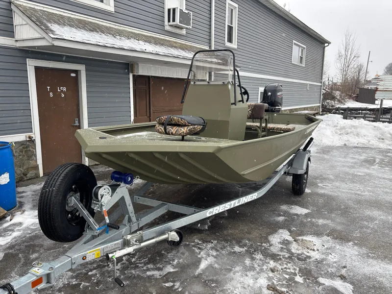 Slide: The Image of 2025 Crestliner 1660 Retriever FCC boat on trailer, parked in snowy driveway. - 5