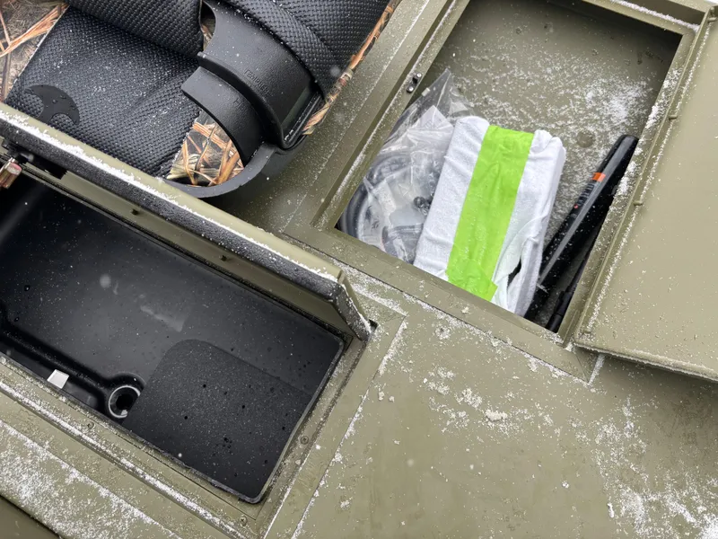 Slide: The Image of 2025 Crestliner 1660 Retriever FCC boat storage compartments with gear and seating. - 7