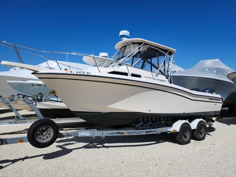 Slide: The Image of 2006 Grady-White Journey 258 boat on trailer under clear blue sky. - 0