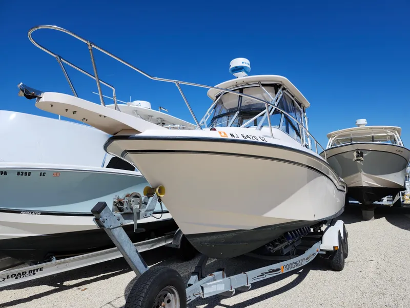 Slide: The Image of 2006 Grady-White Journey 258 boat on trailer under clear blue sky. - 1