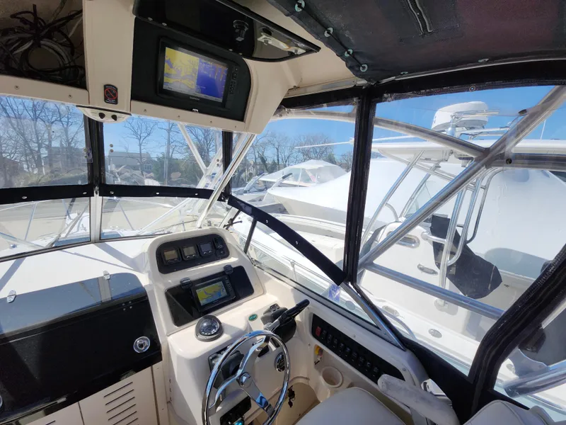 Slide: The Image of 2006 Grady-White Journey 258 boat cockpit with navigation equipment and steering wheel. - 13