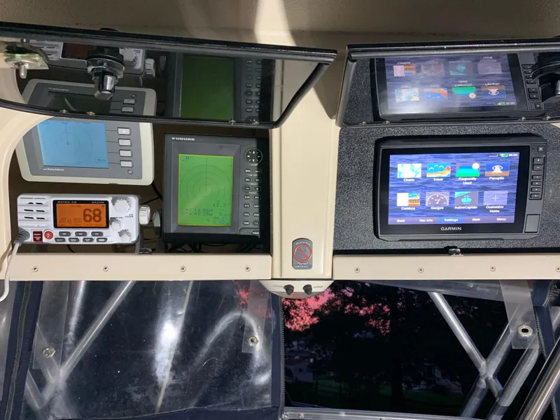 Slide: The Image of Control panel of 2006 Grady-White Journey 258 boat with navigation and communication equipment. - 15