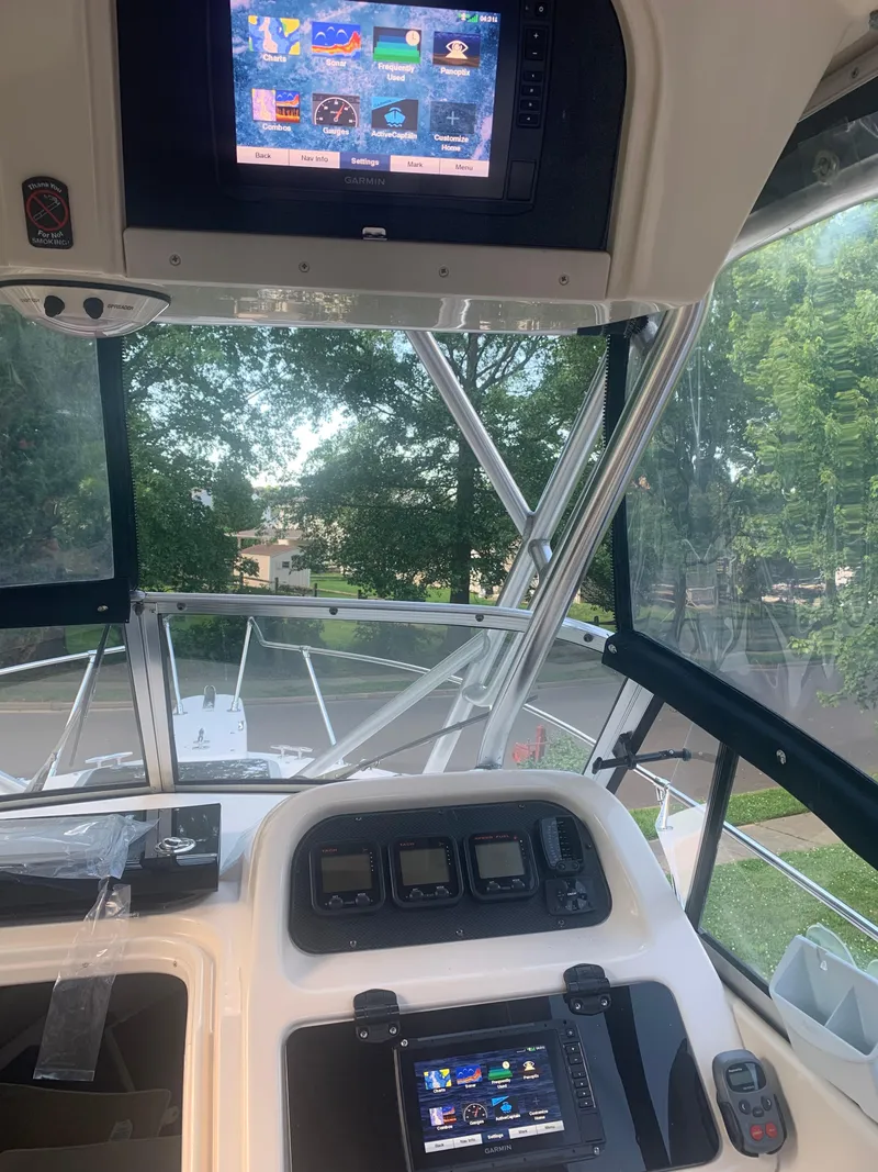 Slide: The Image of 2006 Grady-White Journey 258 boat cockpit with modern navigation displays. - 19