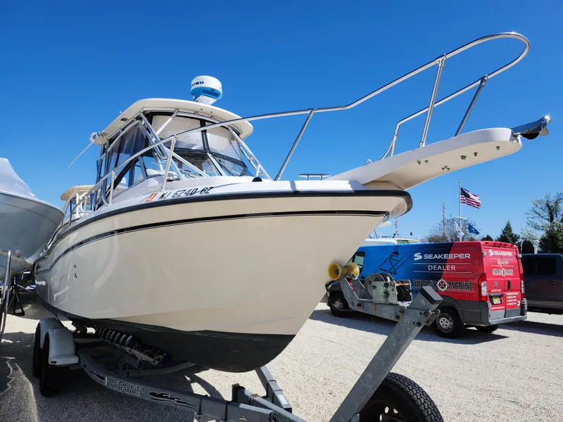 Slide: The Image of 2006 Grady-White Journey 258 boat on trailer, clear sky background. - 2