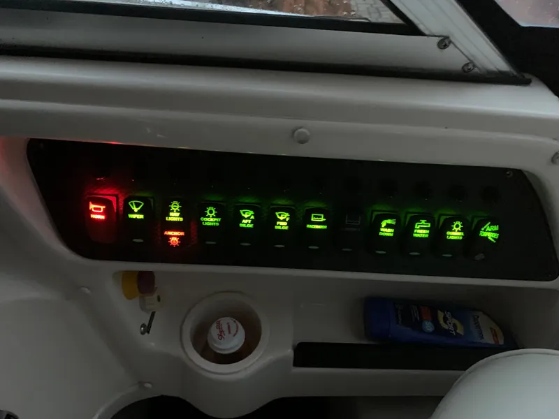 Slide: The Image of Control panel of a 2006 Grady-White Journey 258 boat with illuminated switches. - 20