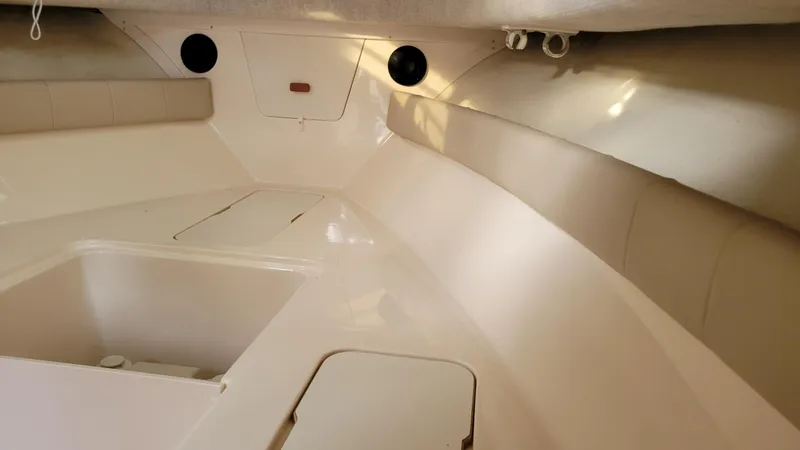 Slide: The Image of Interior cabin of 2006 Grady-White Journey 258 boat, featuring seating and storage compartments. - 23