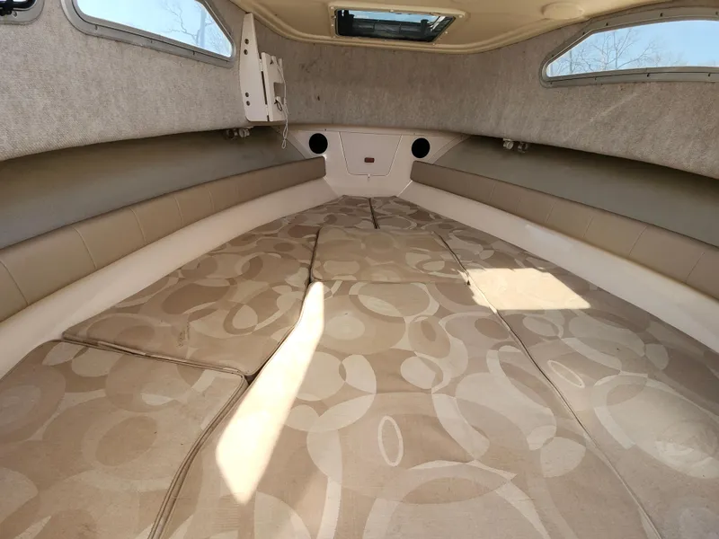 Slide: The Image of 2006 Grady-White Journey 258 cabin interior with patterned cushions and side windows. - 24