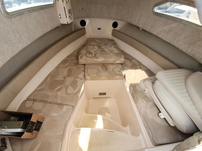 Slide: The Image of 2006 Grady-White Journey 258 boat interior with cushioned seating and storage. - 25