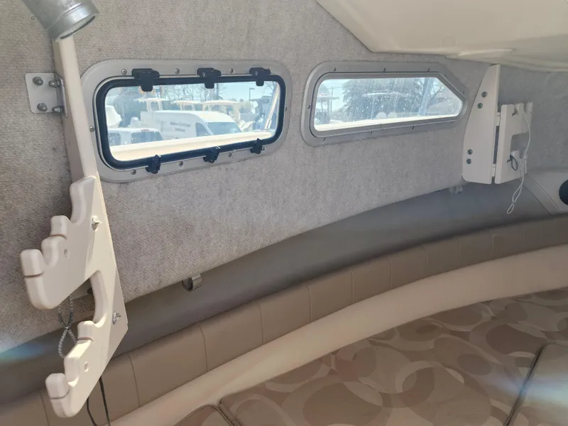 Slide: The Image of 2006 Grady-White Journey 258 cabin interior with windows and seating. - 26