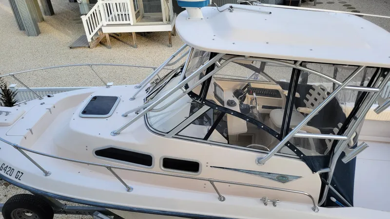 Slide: The Image of 2006 Grady-White Journey 258 boat with enclosed cabin and sleek design. - 3