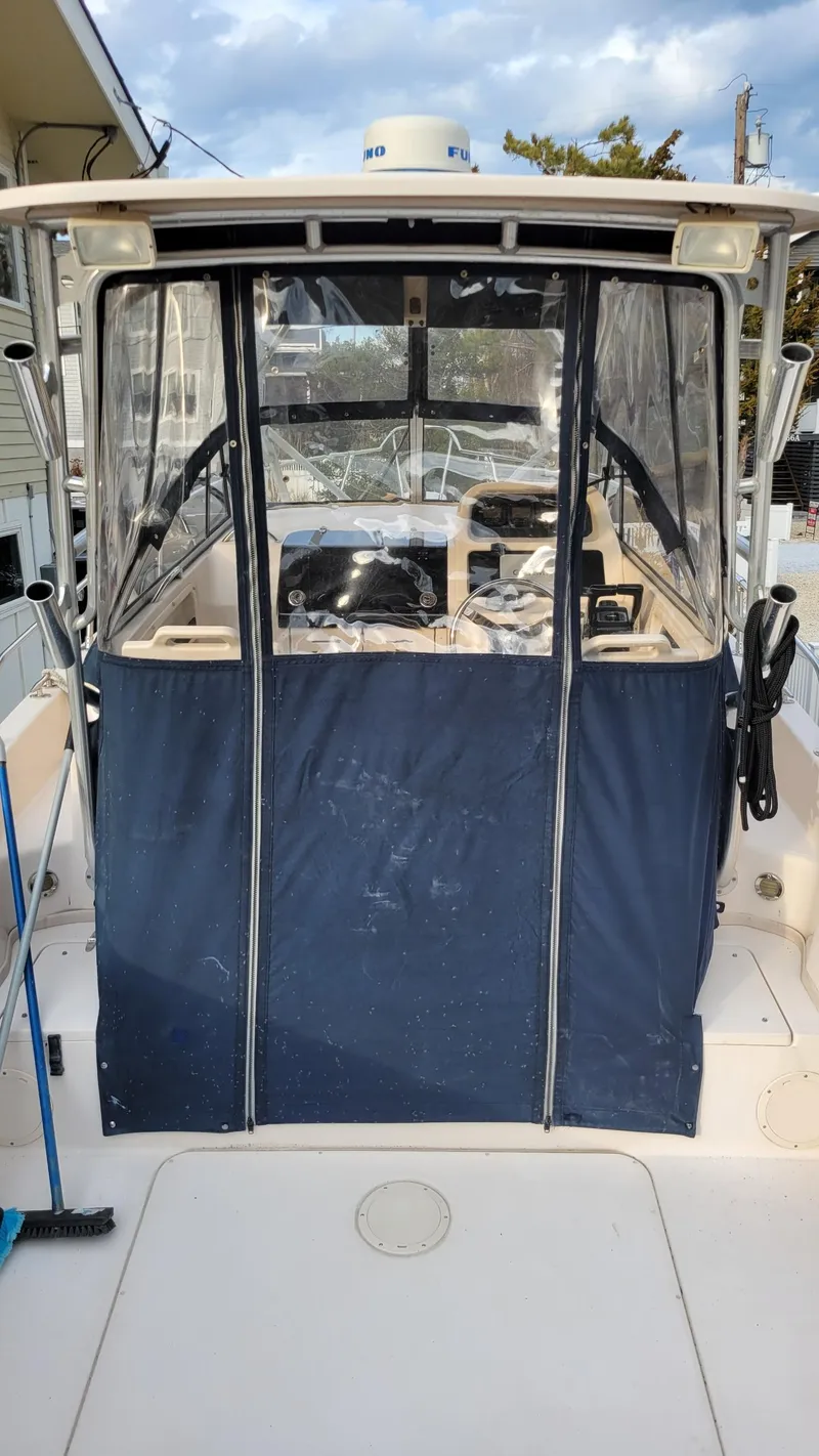 Slide: The Image of 2006 Grady-White Journey 258 boat with enclosed cockpit, docked outdoors. - 30