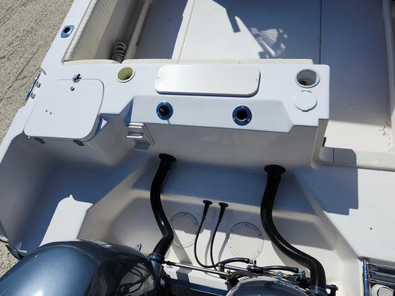 Slide: The Image of 2006 Grady-White Journey 258 boat interior with dual engines and control panel. - 35